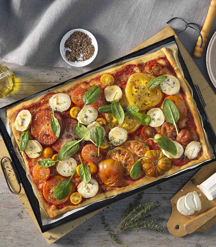 Pizza mit Ziegenkäse und bunten Tomaten